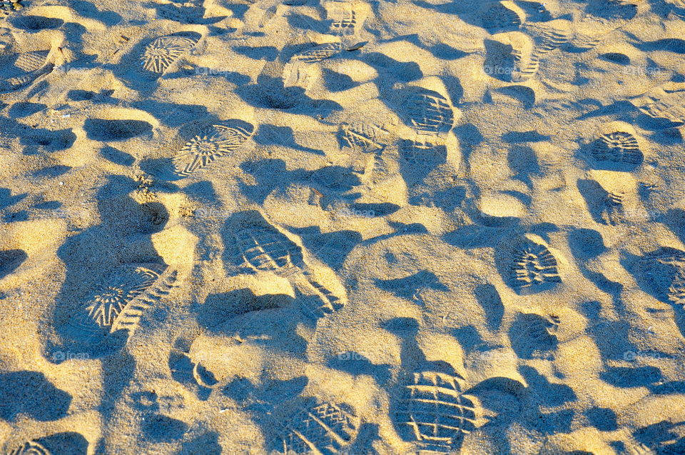 Shoe prints on sandy beach