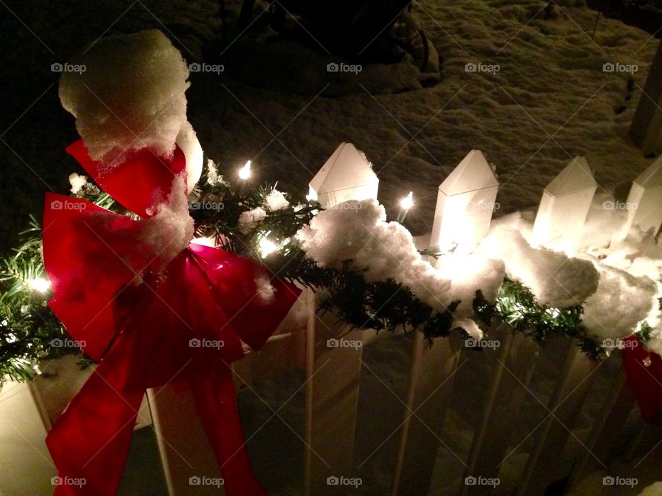 Snow, garland, bow, and fence