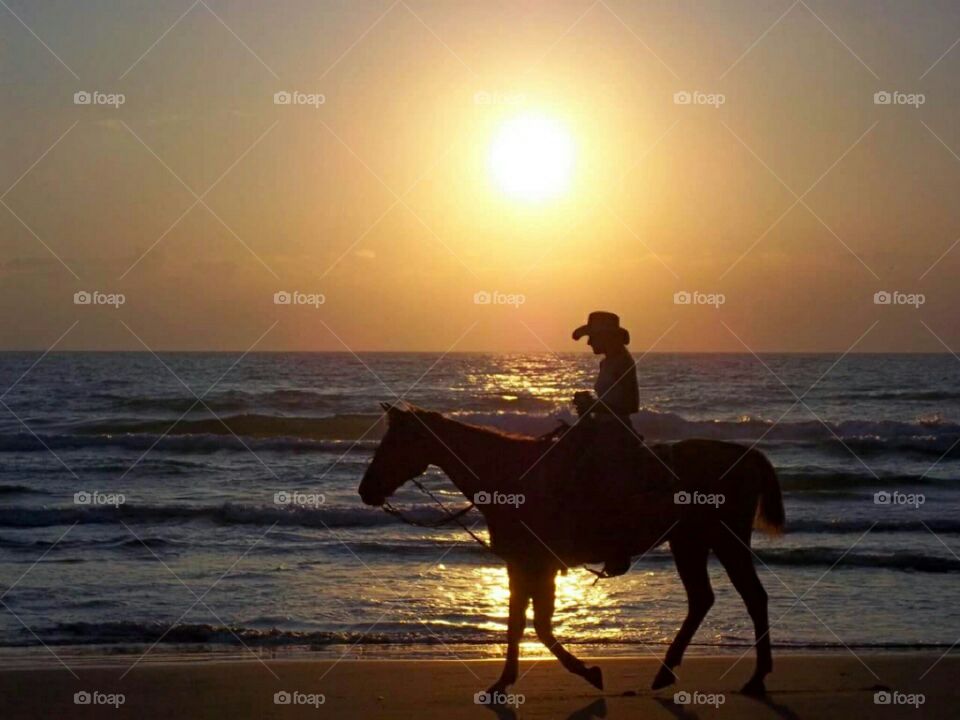 Girl riding a horse on the beach at South Padre Island,  Texas.