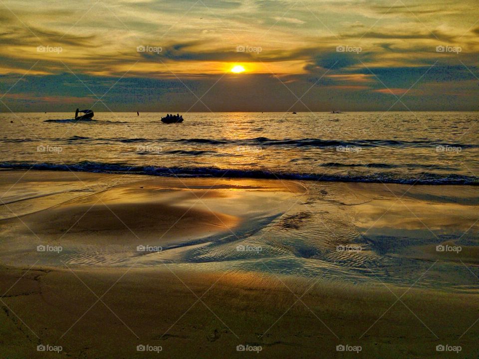 Sunset and the reflection on the beach.