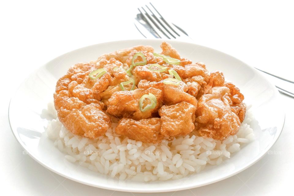 Thai omelette with rice on a white plate.