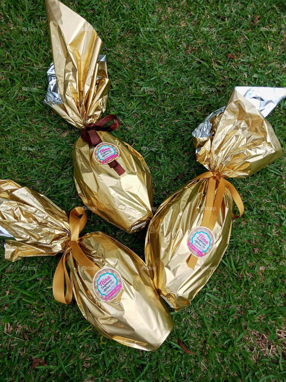 Three wrapped chocolate eggs