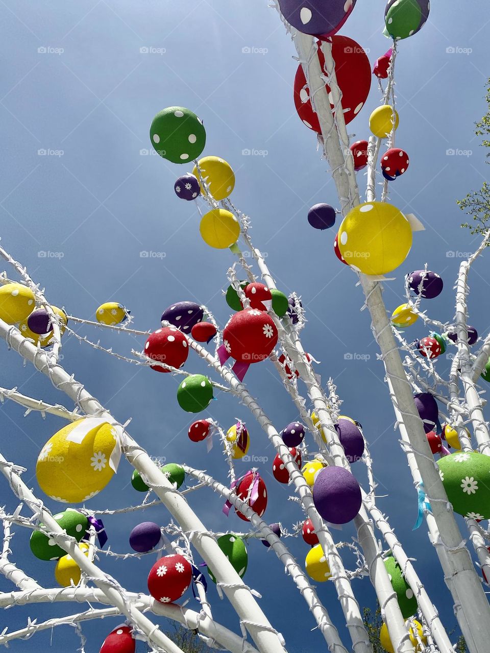 Multicolored Easter Eggs grown up at trees branches