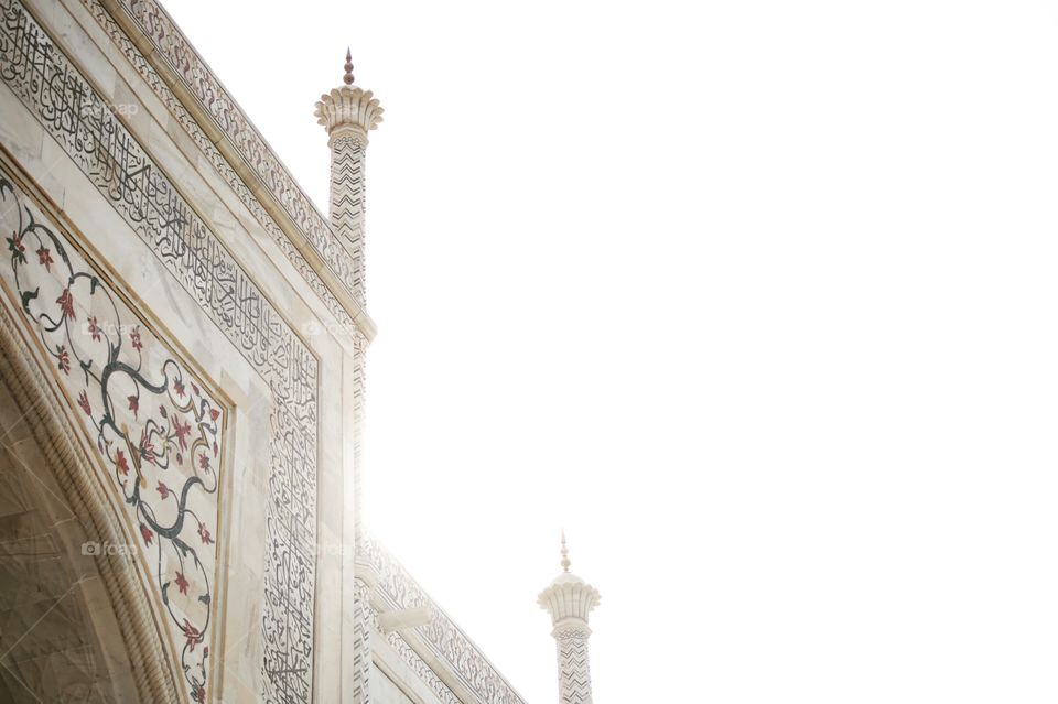 Spires on the Taj Mahal at sunset.