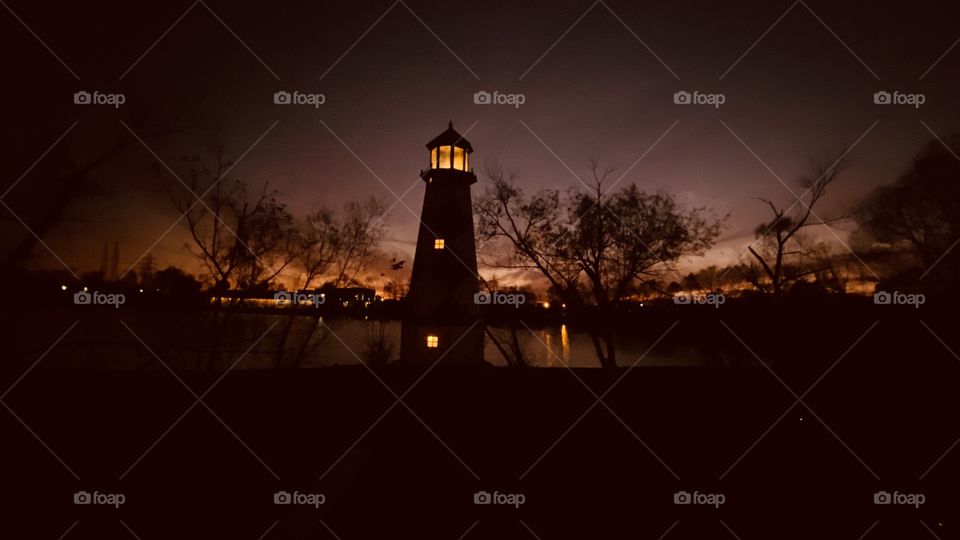 High Clouds adjusting the sky during Sunset. Colors radiating within all the feathering of clouds with wind patterns. More Vivid Colors showing the Twilight fade of Sunset. Lighthouse has its place in the Color of Night. 