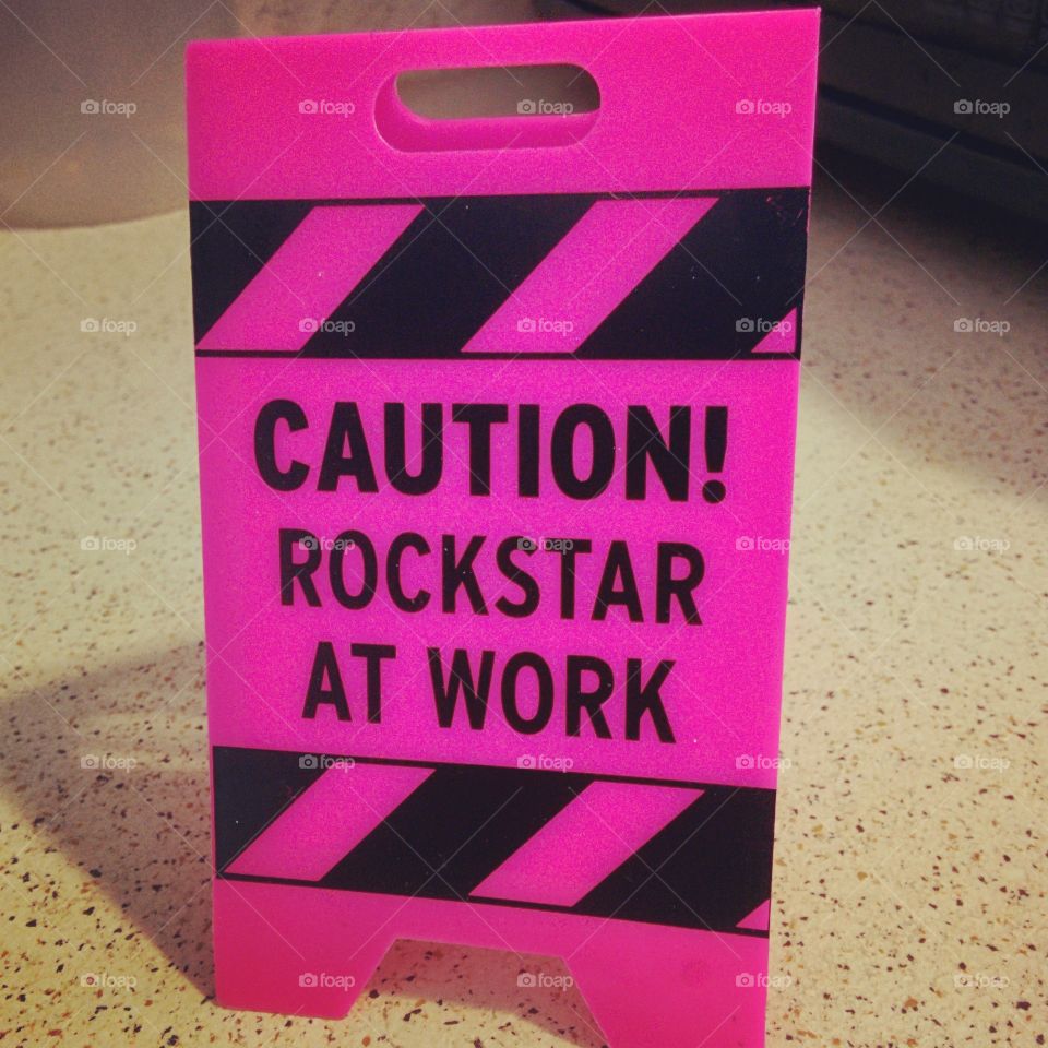Caution! Rockstar at work sign. This hot pink sign warns: Caution! Rock star at work
! Just what you want for warning others that you are hard at work