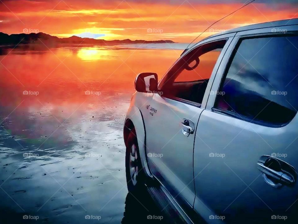 Driving on the beach at sunset