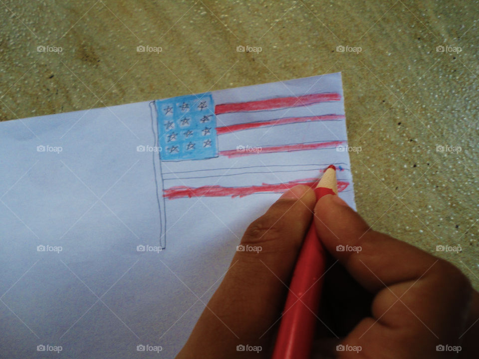 child drawing flag