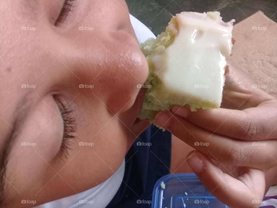 Child eating a delicious Lemon cake