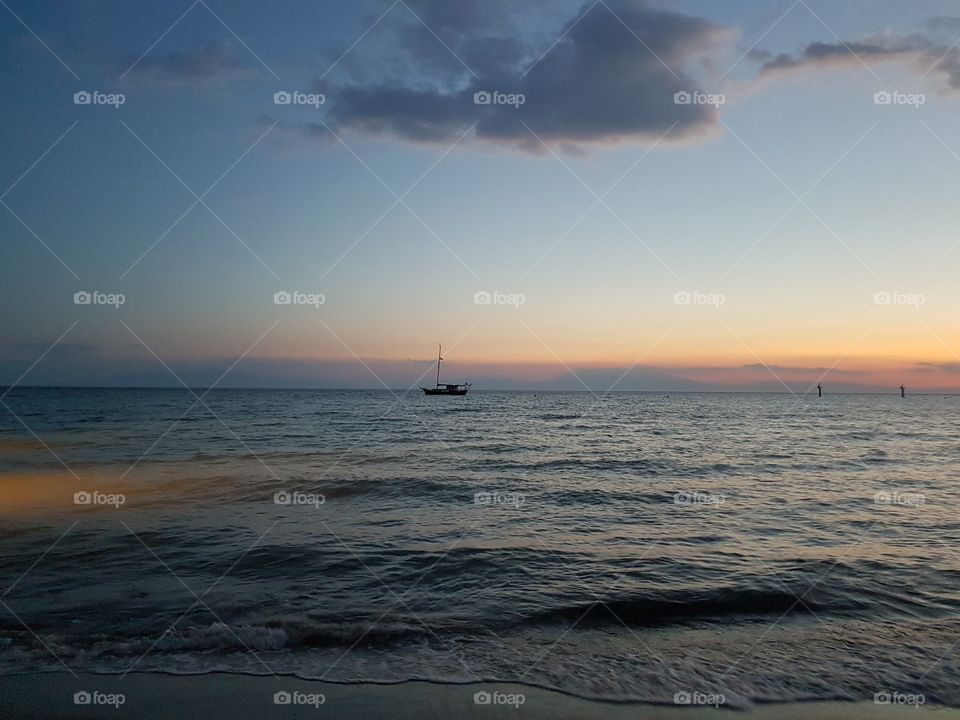 fishing boat on the sea, sunset at Sani beach resort, Greece, Europe