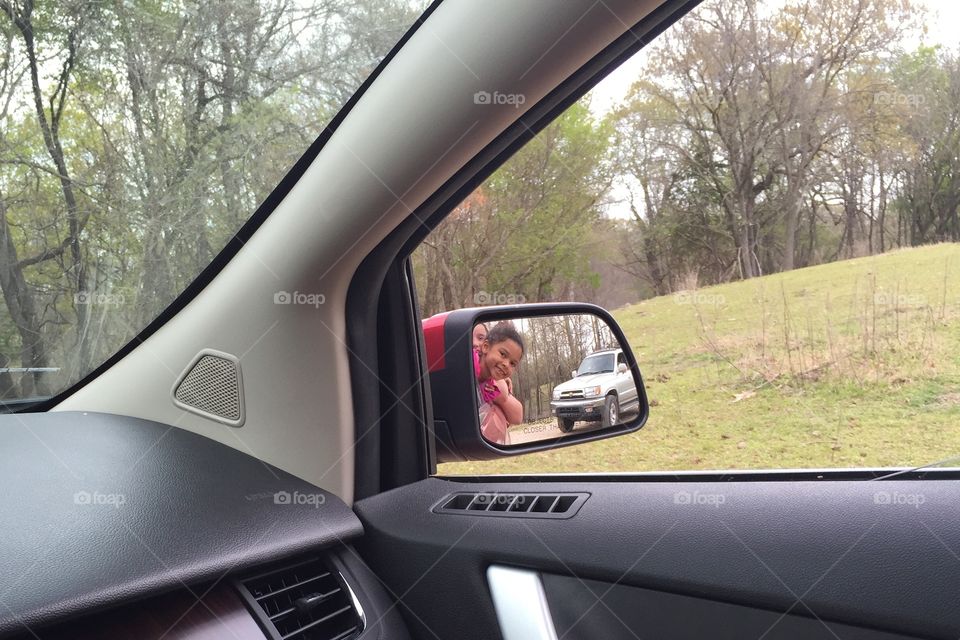 Girls in rear view mirror