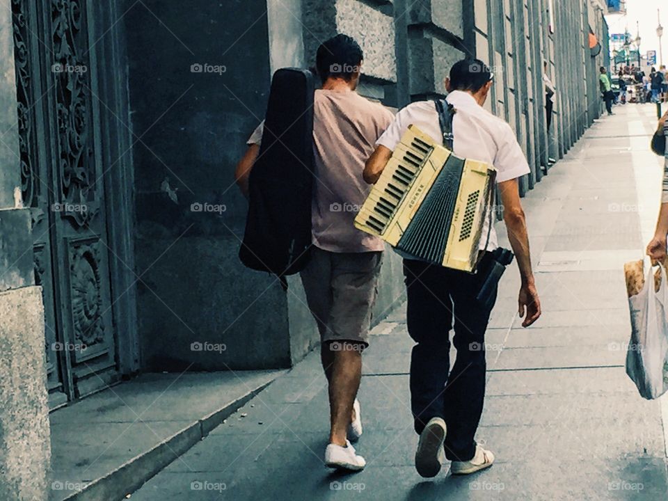 Musicians walking on the street with their instruments 