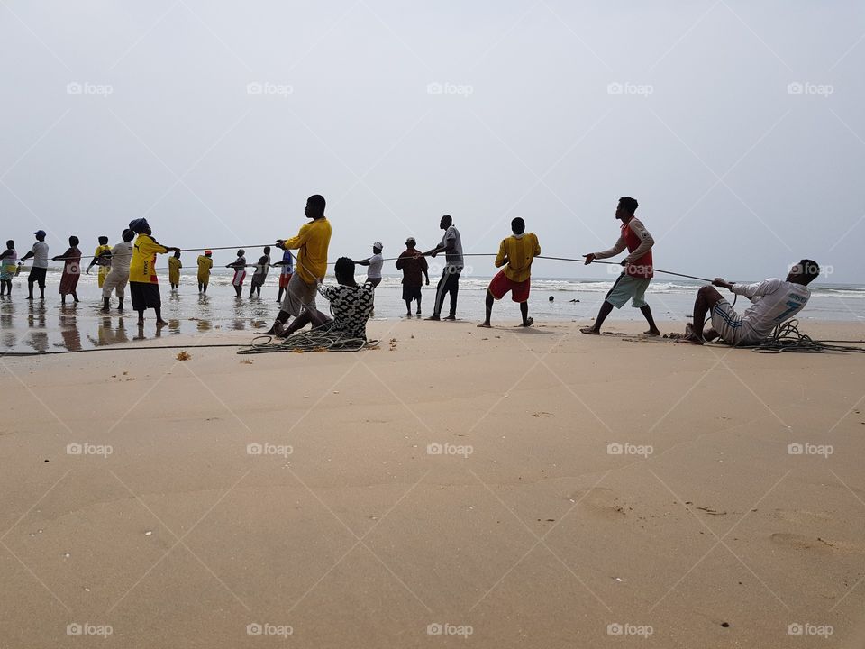 A group of family fishing sustainably in the coastal waters of labadi beach in Ghana