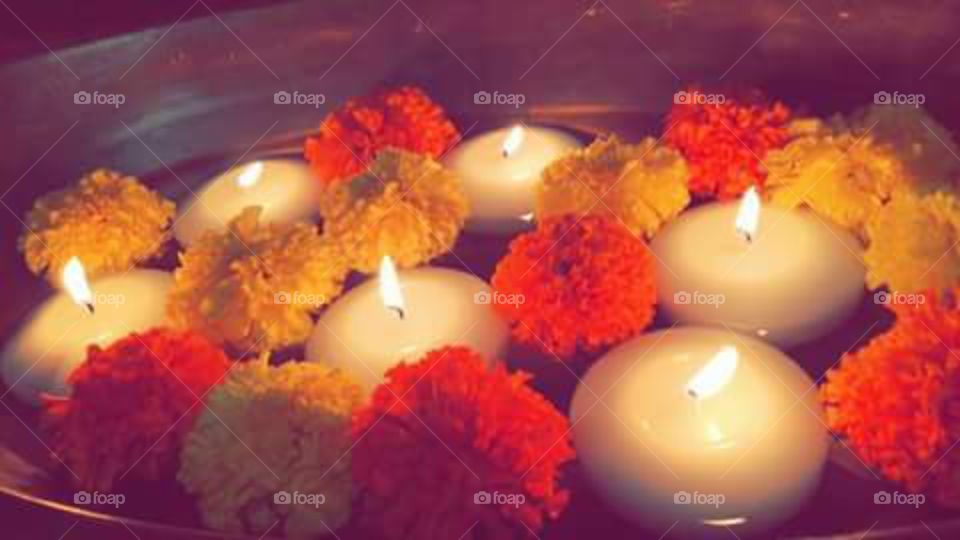 Night time.... romantic candles with orange and yellow flower.....