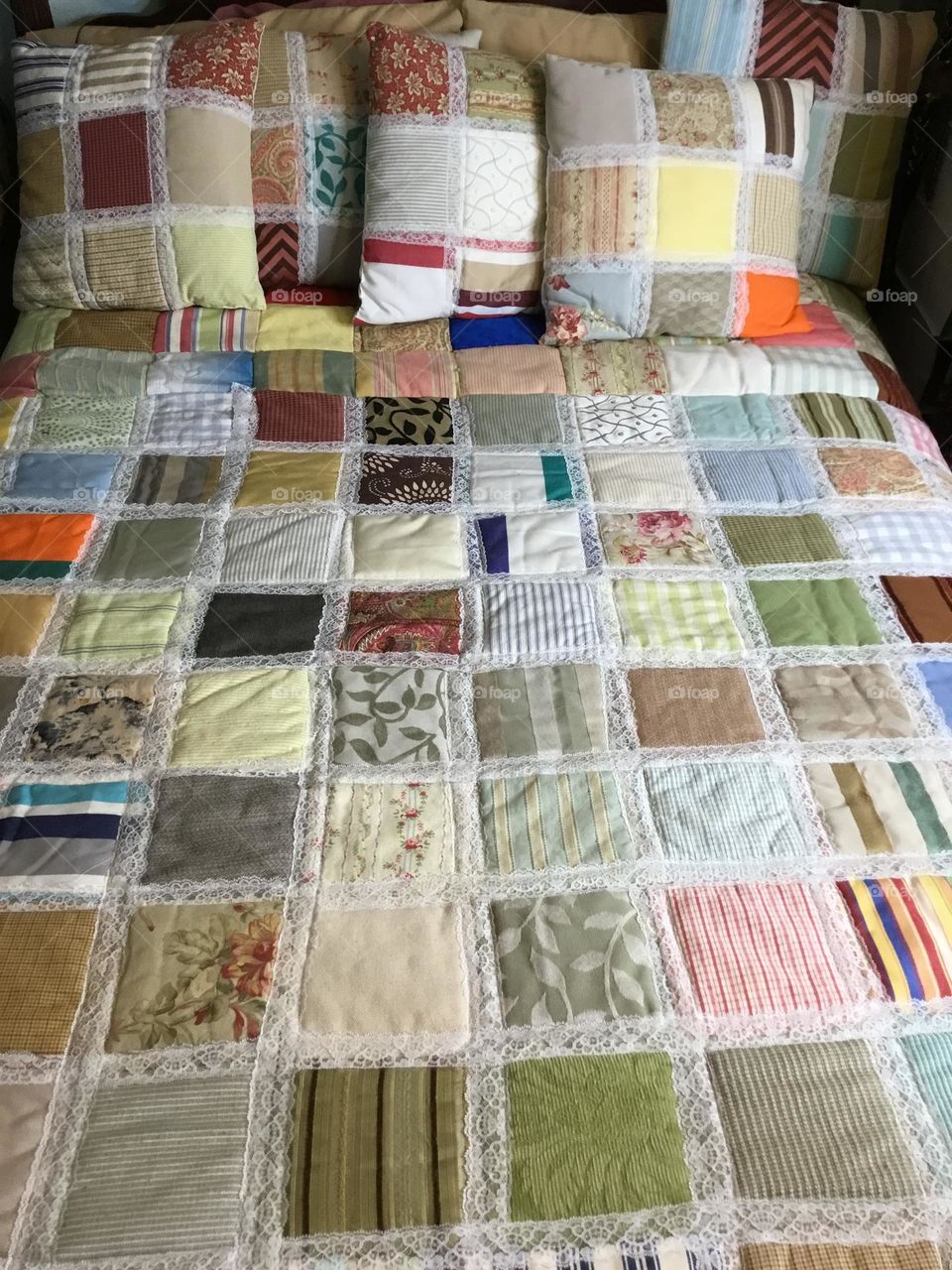 A patchwork quilt - a quilt in which the top layer may consist of pieces of fabric sewn together to form a design. Originally, this was to make full use of leftover scraps of fabric, but now fabric is often bought specially for a specific design.