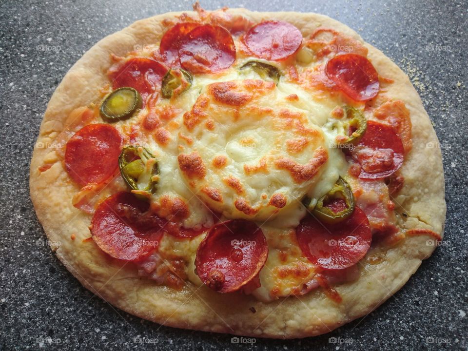homemade pizza, olive oil, oregano, garlic, mozzarella, bacon, pepperoni, jalapeño