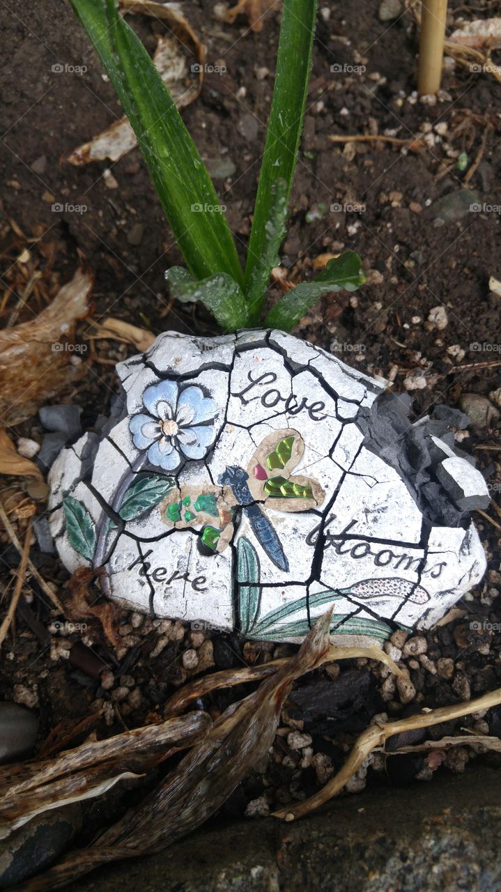 Broken promises. Well-weatheted inspirational garden plaque. Love blooms here.