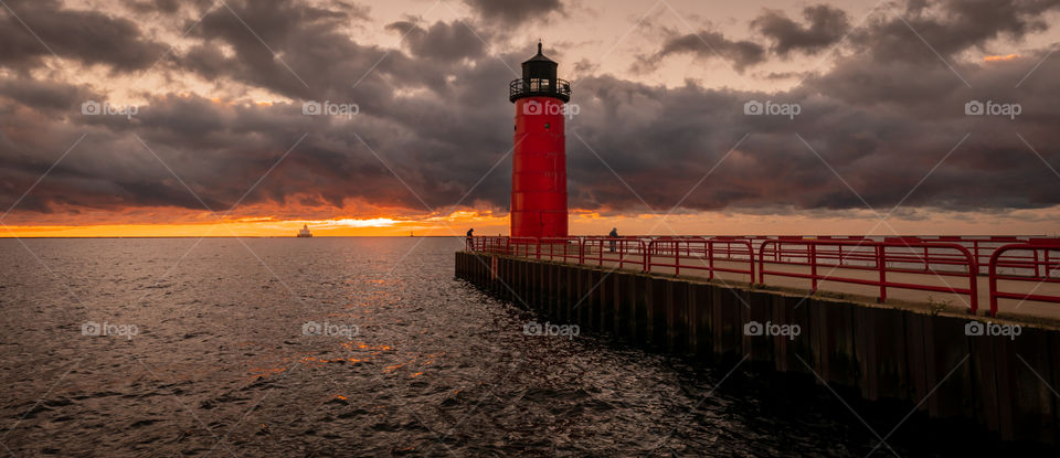 Read lighthouse at sunrise with stormy skies in Milwaukee Wisconsin