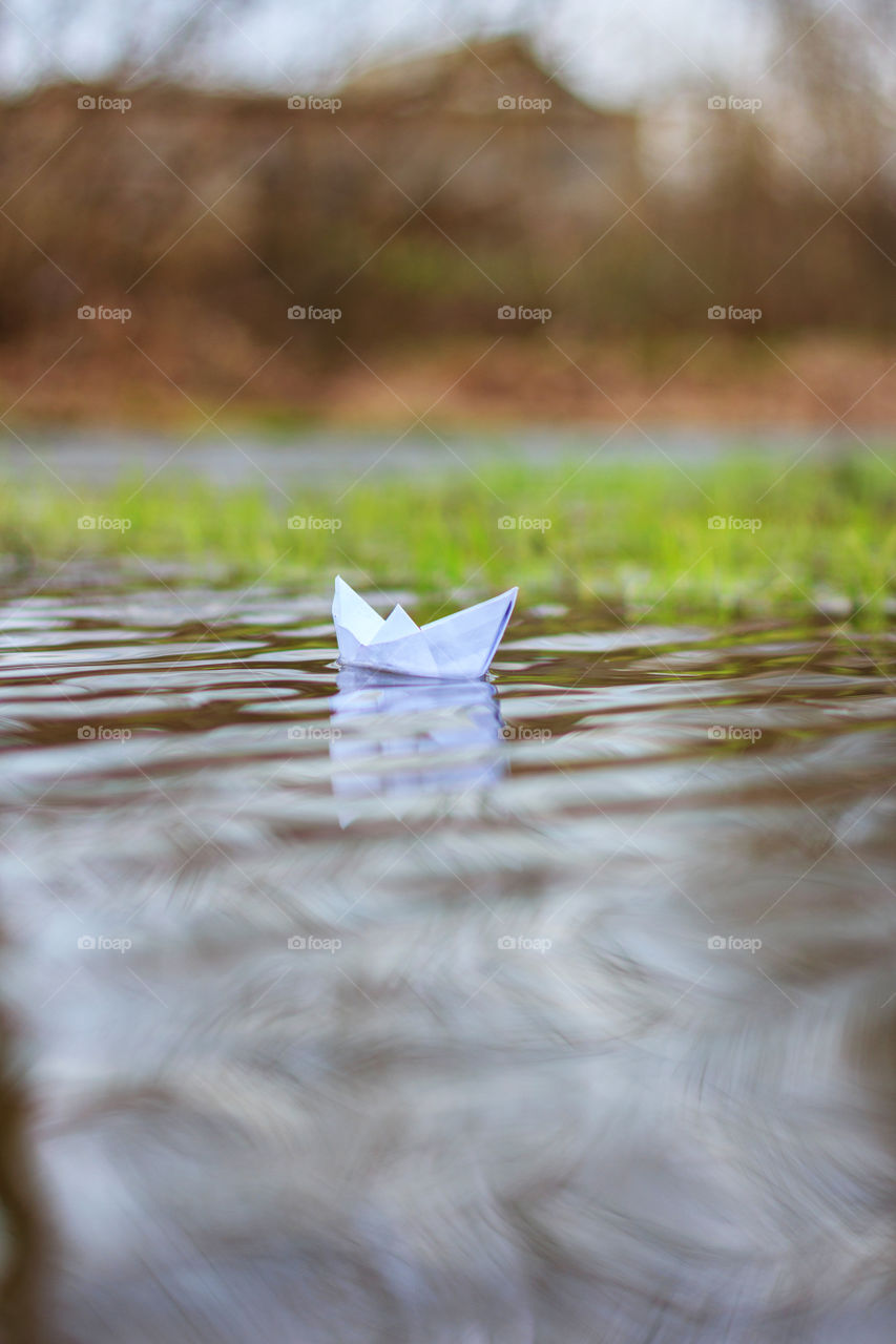Paper boat floating on water