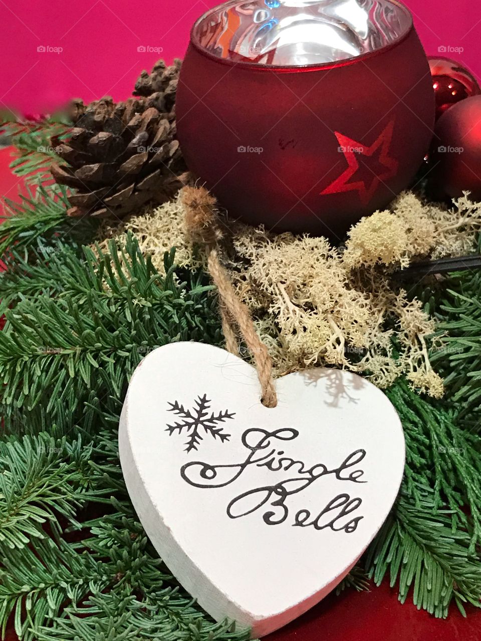 A wooden white heart with text jingle bells