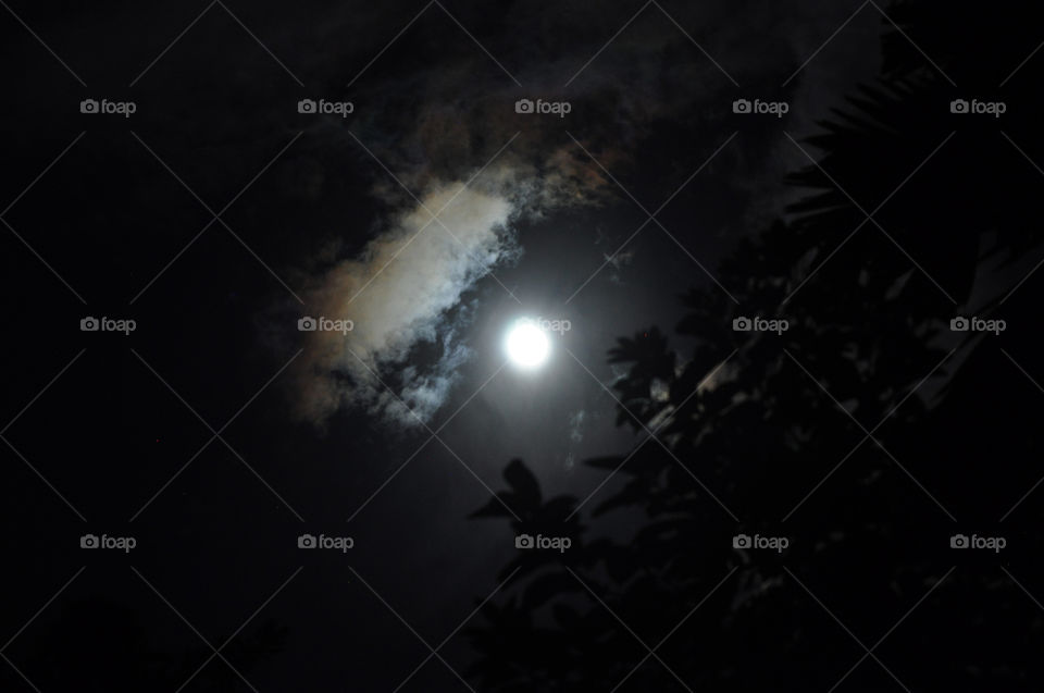 The moon light up the night sky cloud