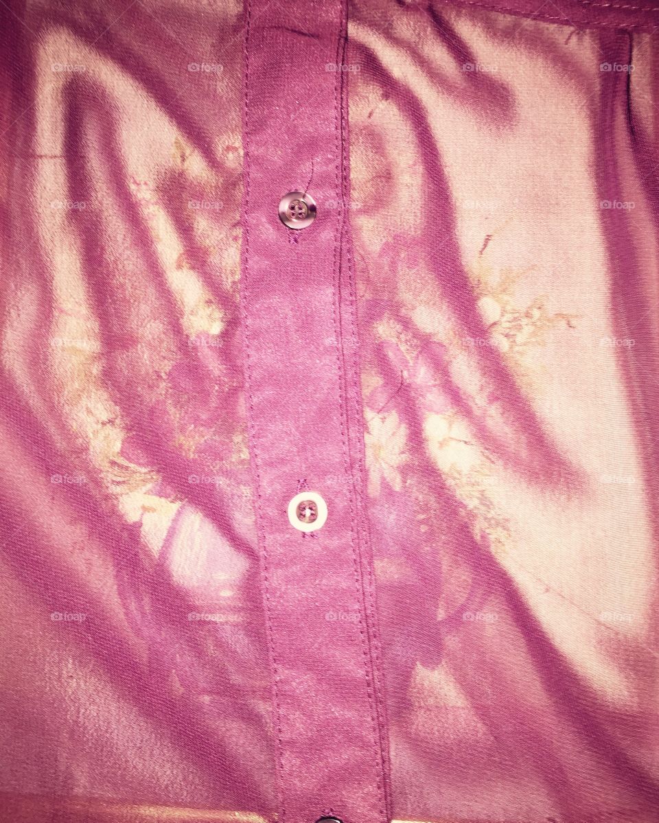 Sheer purple shirt with buttons that was a birthday gift from my daughter laid over a painting on my bed causing this interesting effect.