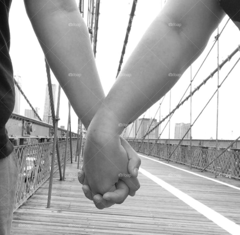 Love on the bridge . Walking across Brooklyn Bridge hand in hand