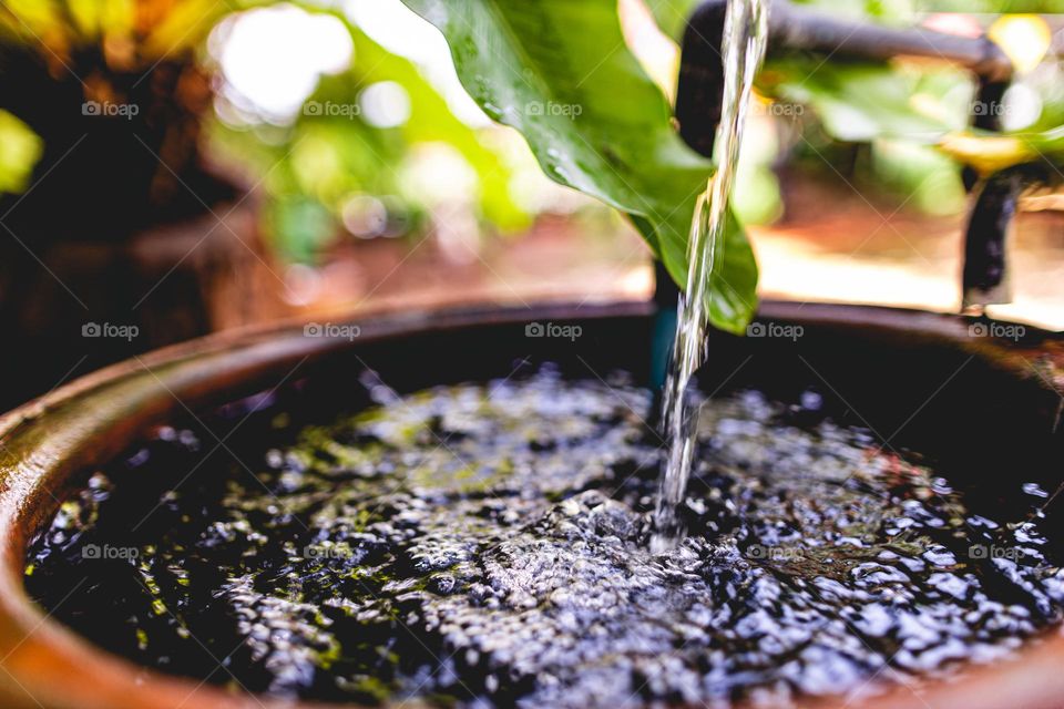 Water filling up in a clay jar
