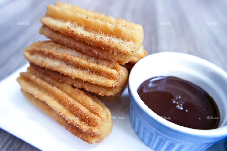 Close up of Churros and chocolate dip.