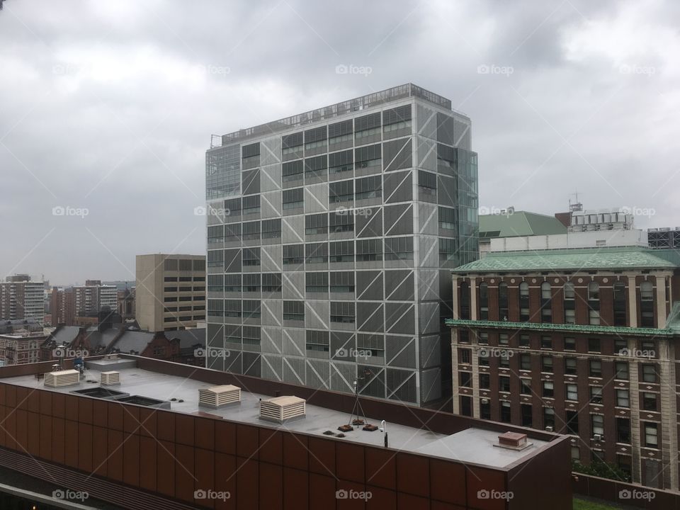 Tall metal clad building with glass and concrete in New York City, at Columbia university 