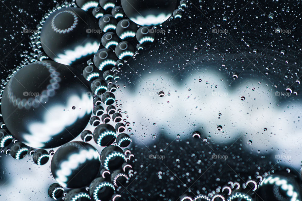 Small bubbles of vegetable oil in water close-up.