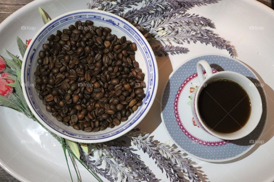 A cup of coffee and coffee beans