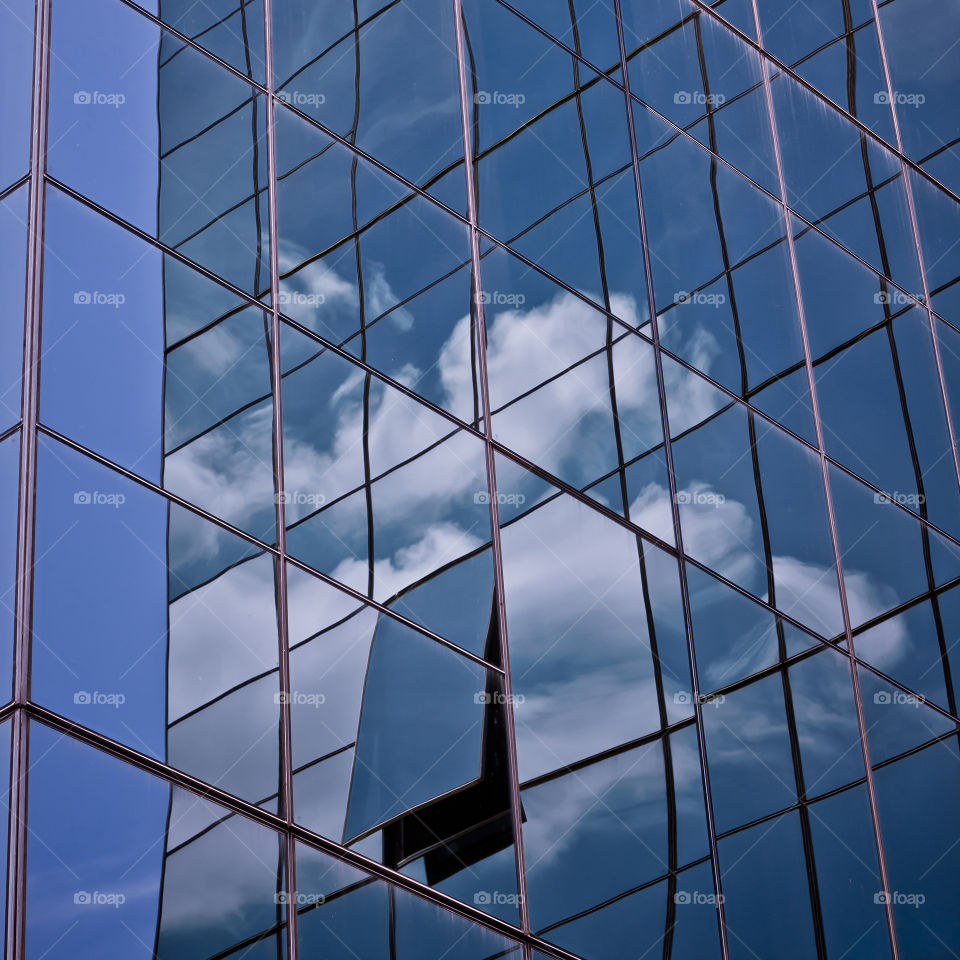 Escape.... is sky the limit?. Reflection of clouds and blue sky in an open window