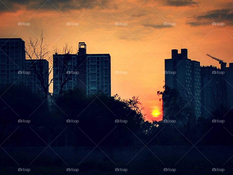 Sun hiding from City