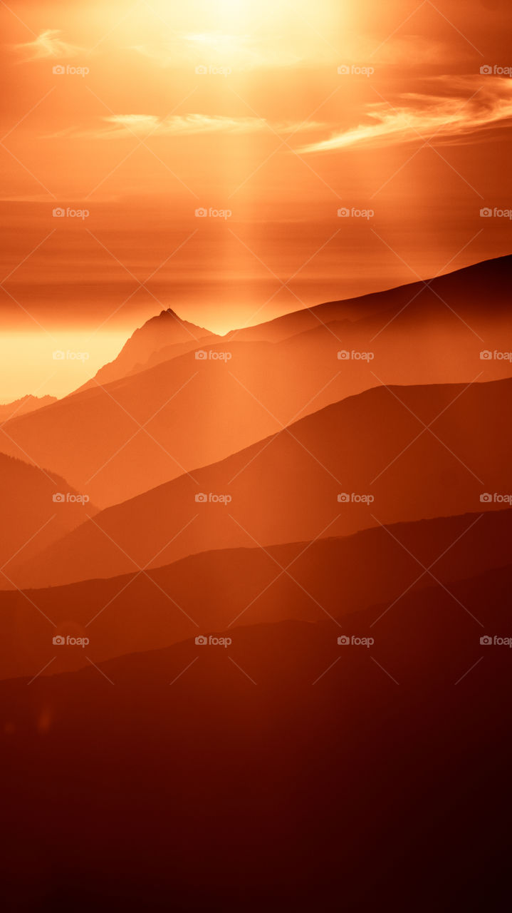 An inspiring red mountain landscape. Tatry mountains in Slovakia. A beautiful wallpaper for smartphone screen. Red abstract gradient with perspective.