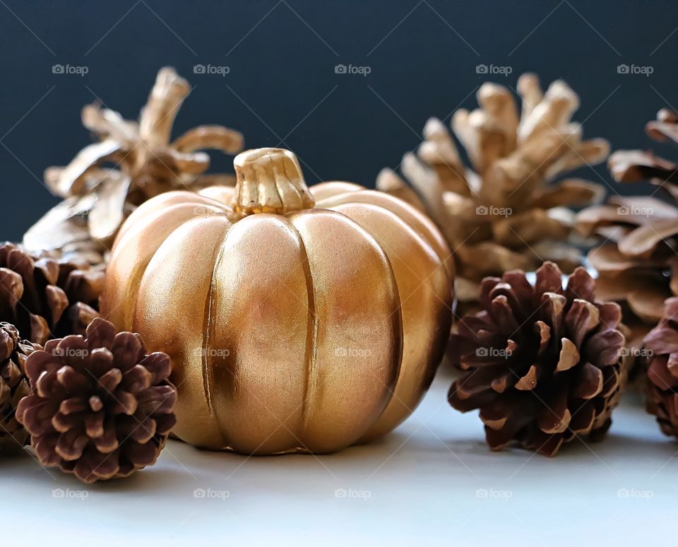 Fake pumpkin with pine cone