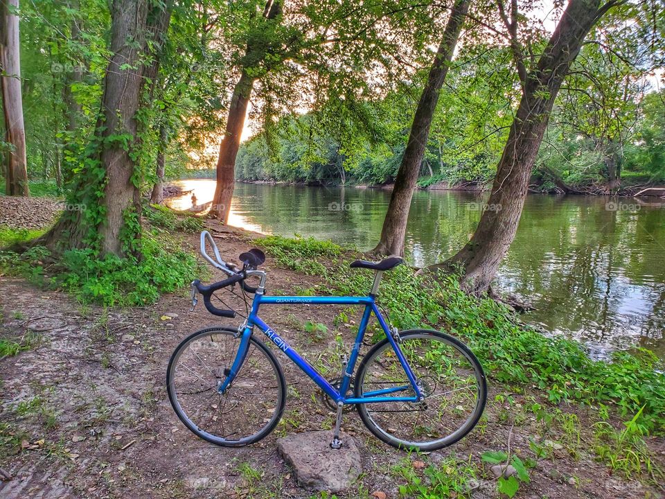 bike by river at sunset