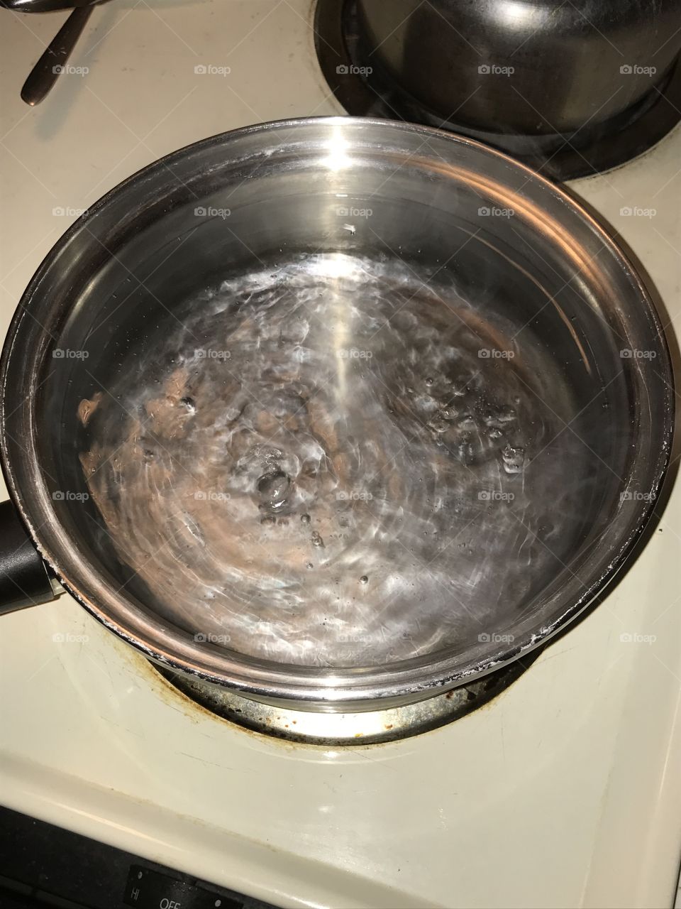 To the boiling point. The water from the faucet is appropriately distilled in the pan to make it drinkable.