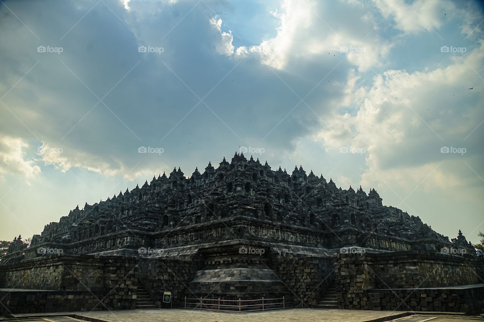 the pyramid shape of borobudur temple when sunset is coming