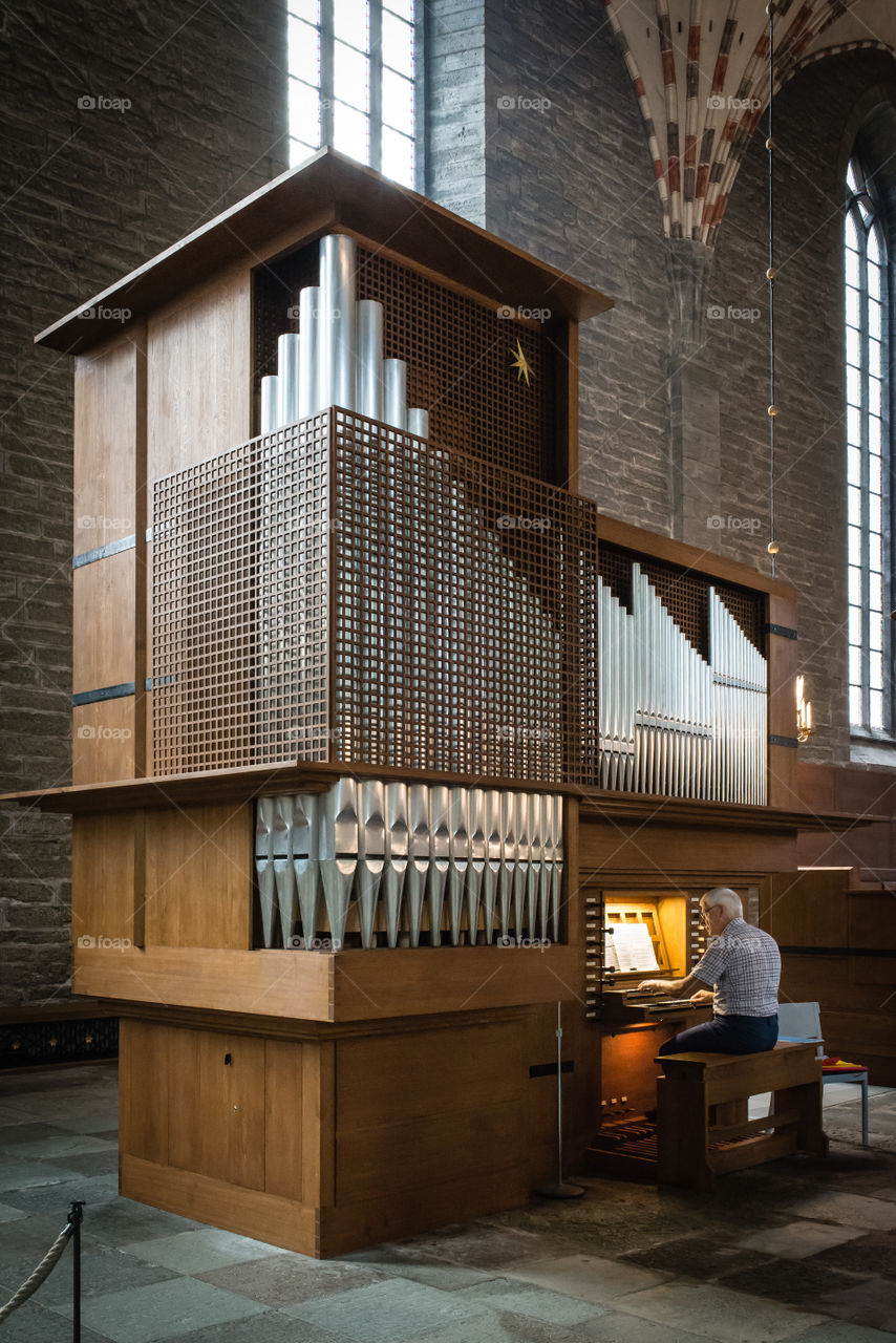 Vadstena Monastery quire organ. A man is playing the quire organ ( the smaller of the two organs) in the Vadstena Monastery Church, Sweden. 