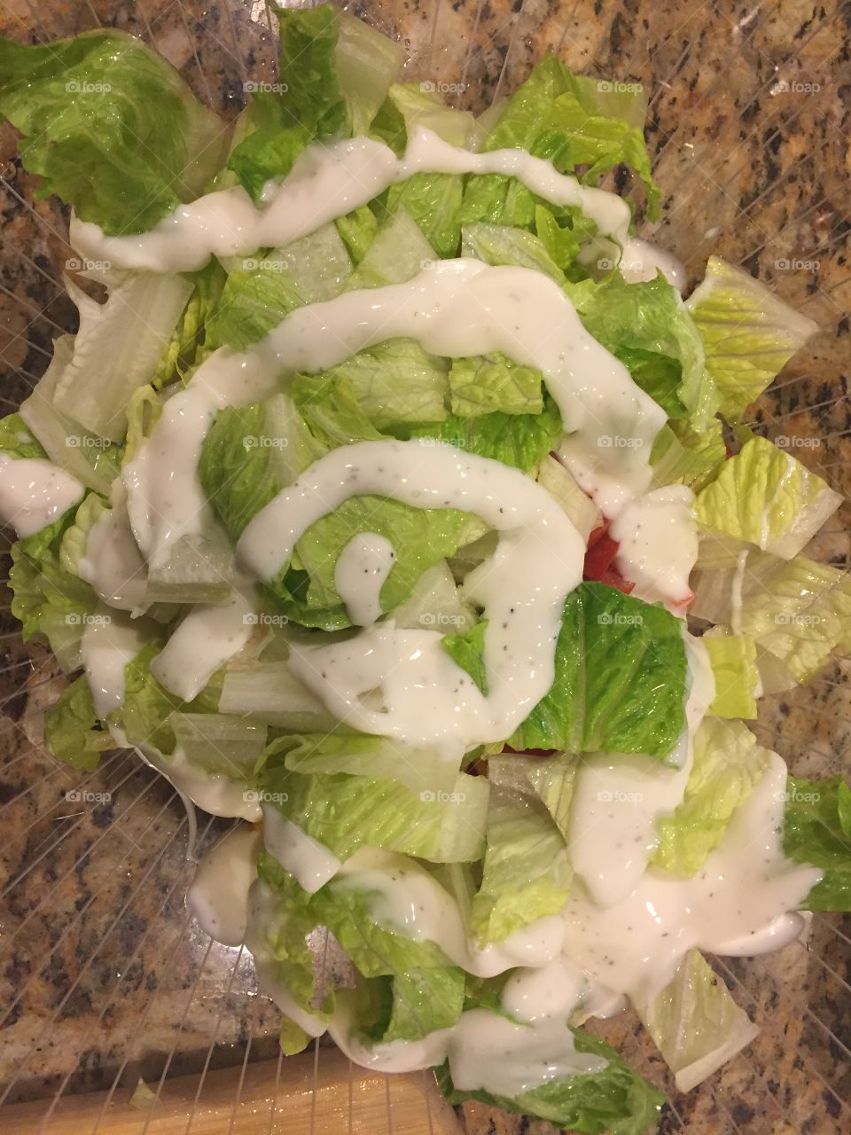 Fresh salad from lettuce and tomatoes and ranch