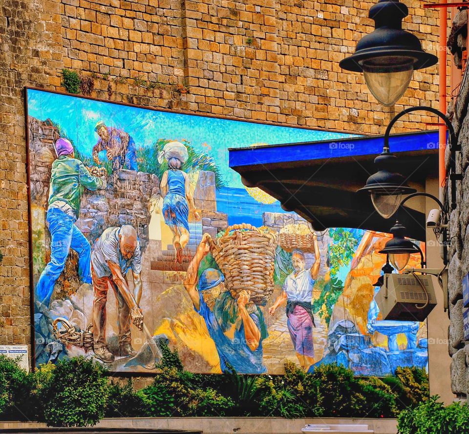 Mural in Monterosso. A colorful mural depicting life's labors in Monterroso Italy 