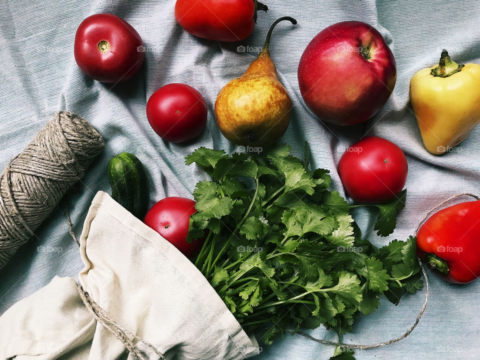 Fresh fruits and vegetable and greenery in reusable rustic bag