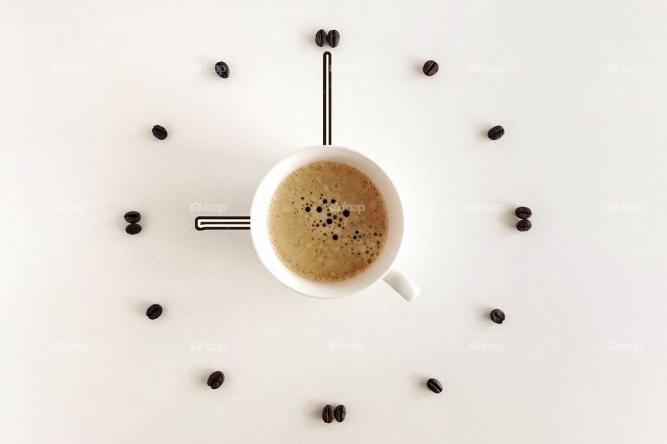cup of coffee and coffee beans in the form of a clock