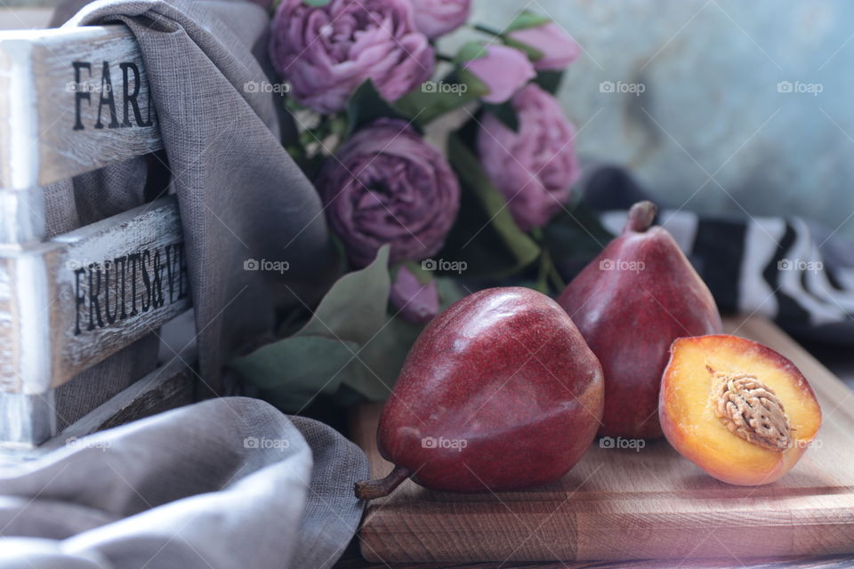 Still life of pears and peaches on the table