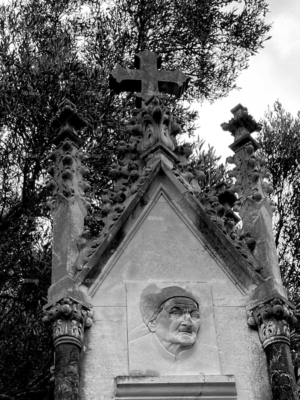 Creepy tombstone in black and white with scary old witch face.