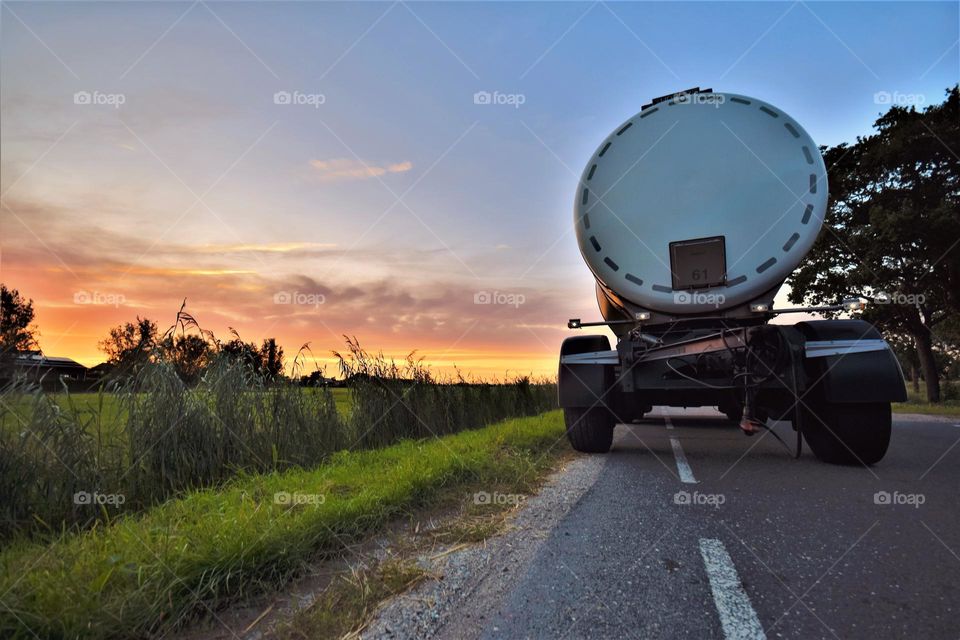 trailer parked by the roadside on the countryside dat dawn with beautiful colored sky