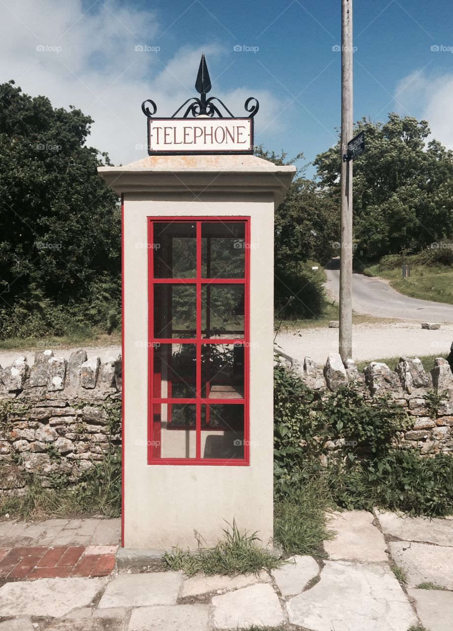 Old telephone box in a derelict village in Dorset, England