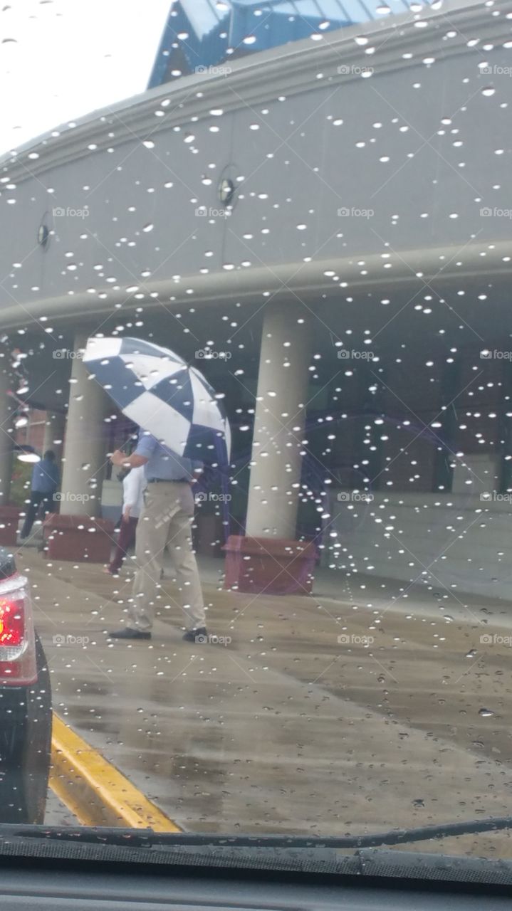 a men. a men under the rain white a umbrella