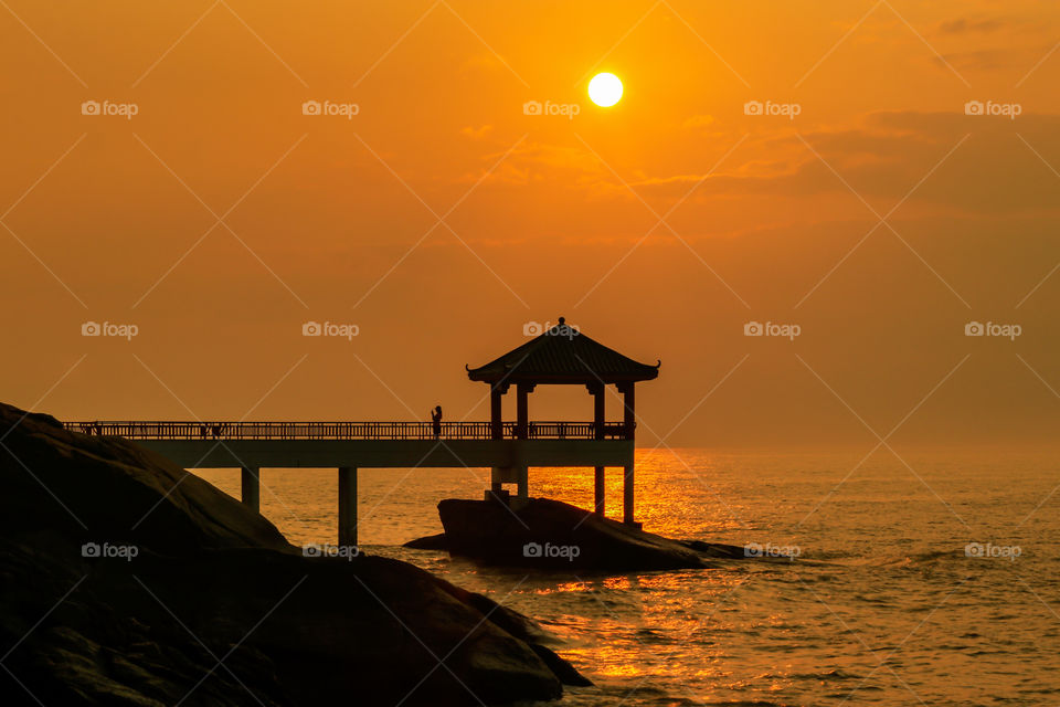Silhouettes of a person in a Coastal View Deck.